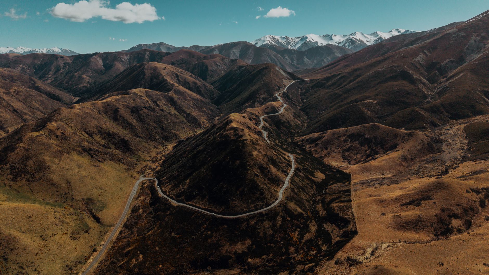Arthur's Pass road winding through snowy mountain ridges