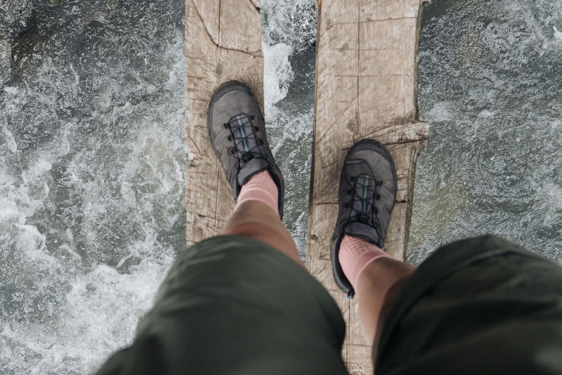 Hiker on wooden boardwalk in Routeburn Track New Zealand