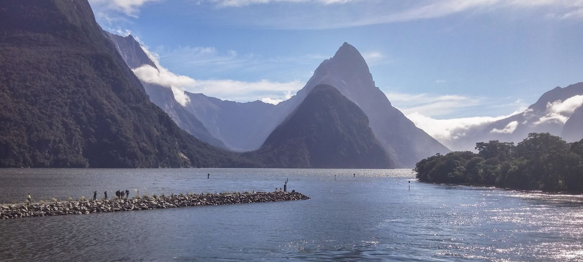 Hiker looking out over Milford Sound peaks